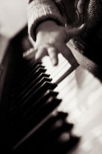 child's finger on piano key
